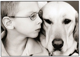 Boy with face pressed against Dog